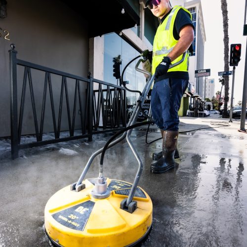 A professional team from Houston Premier Pressure Wash restoring a driveway in Baytown, TX.