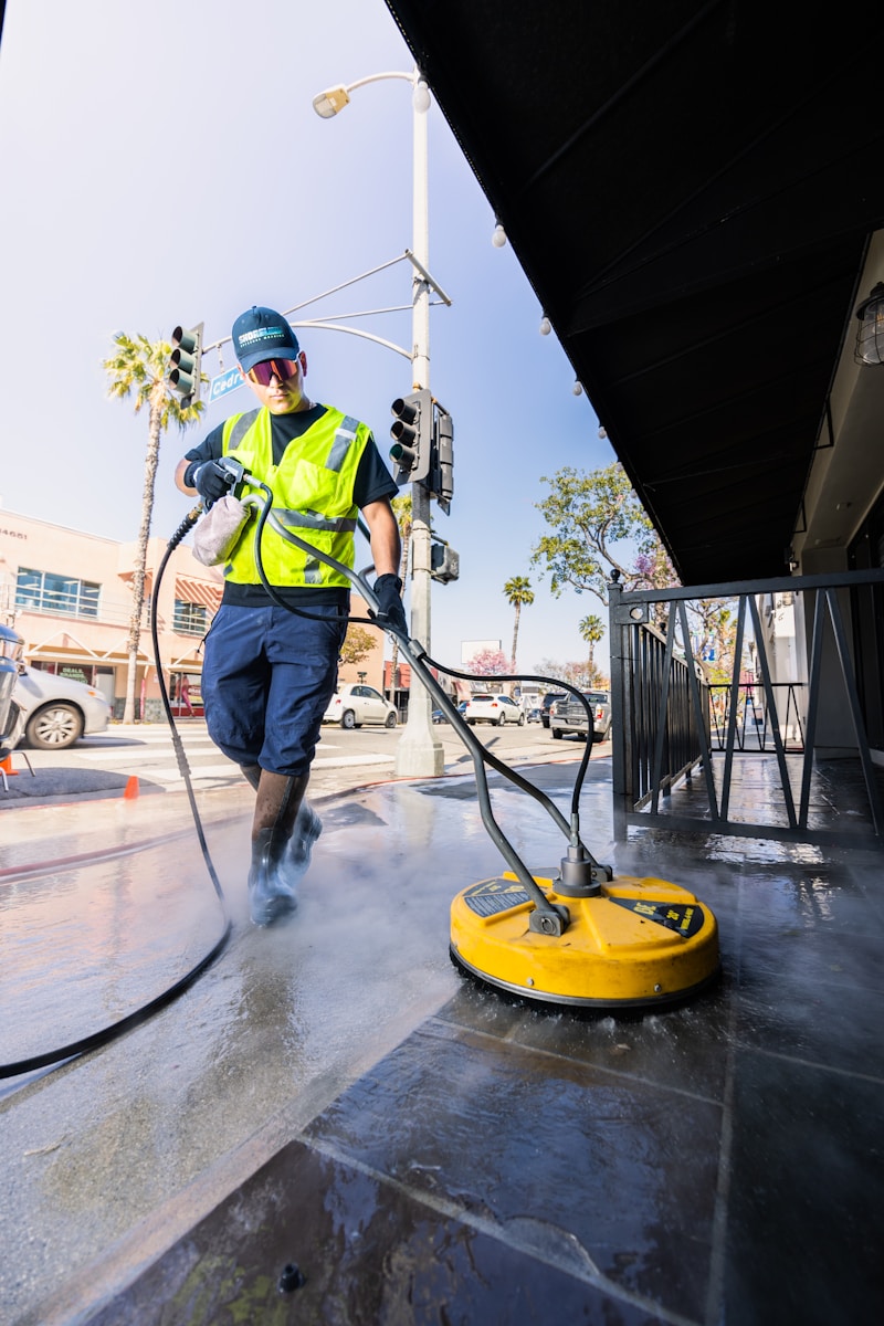 Professional pressure washing team cleaning a driveway in Pearland, TX.